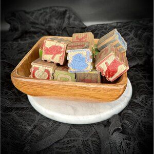 vintage wooden alphabet blocks in a wooden bowl